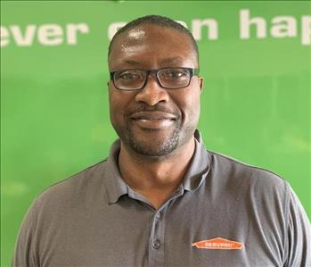 SERVPRO crew member with glasses on and smiling