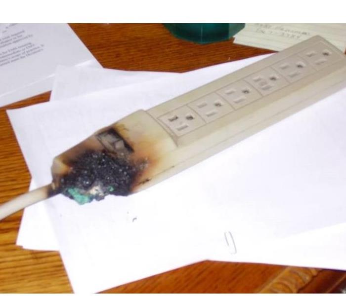 Photo is showing an extension cord burned and damaged.