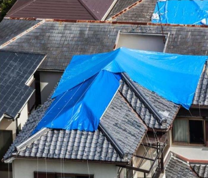 Roof tarp to prevent water damage inside the home.